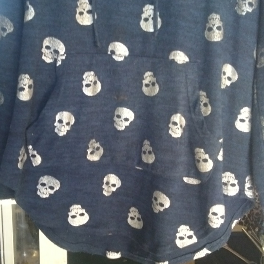 Long sleeve warm Blue with shiny silver skulls sweater with a pocket